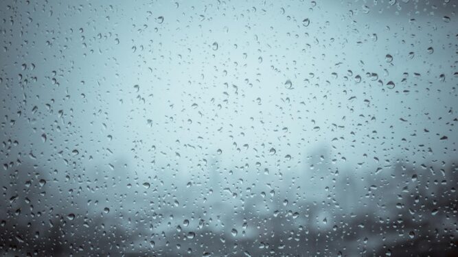 Mevsimsel duygudurum bozukluğu (SAD) hakkında bir SSS göstermek için kasvetli bir günde bir pencereye yağmur damlaları